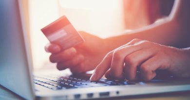 Image of person paying retail price of product on computer