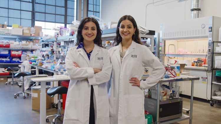 Co-Founders of Rubi Labs standing in white lab coats in a research laboratory,