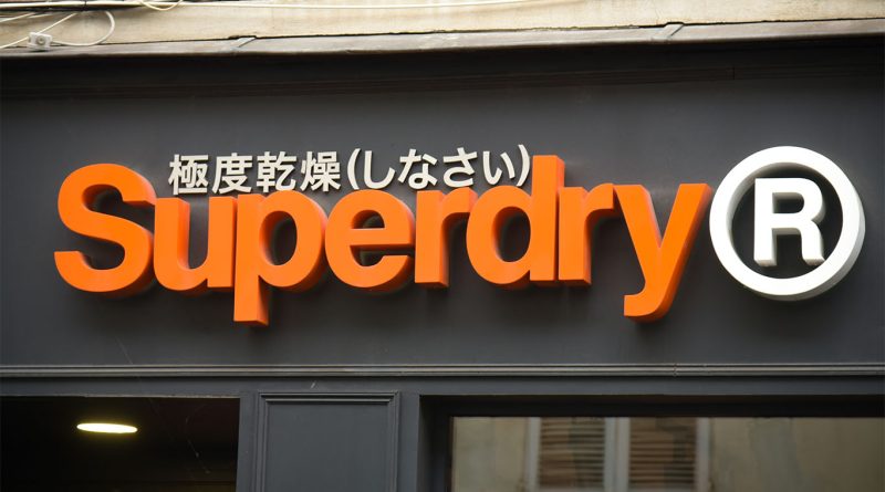 Close-up image of a Superdry storefront displaying the orange and white logo to support business collaboration article