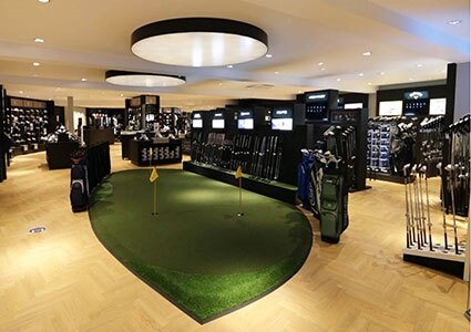 Practice putting green inside American Golf store