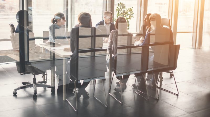 Representatives from companies in a corporate meeting room, discussing partnership strategies.