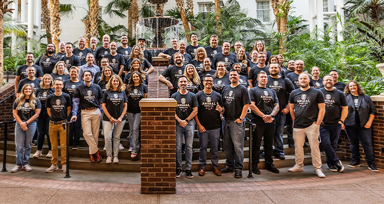 Animal Sypply Company staff standing on steps in front of a fountain