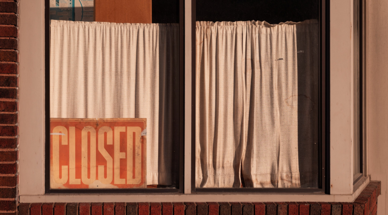 Closed retail store with curtains drawn, symbolizing the ongoing retail apocalypse and store closings