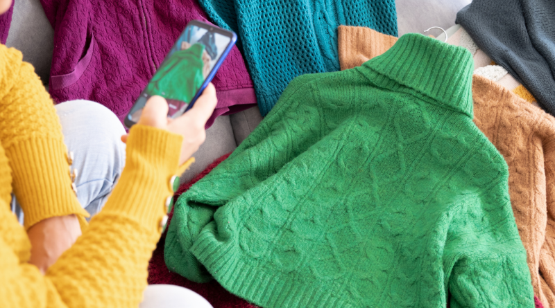 Person photographing colorful secondhand sweaters to sell online, representing the best online thrift stores for sustainable and affordable fashion.