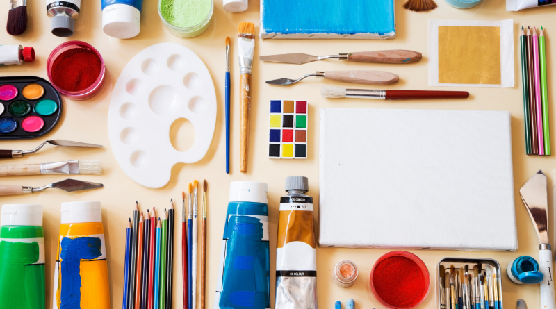 Where to Buy Art Supplies in 2025? Best 6 US Craft Stores Art supplies and craft tools arranged flat, including paints, brushes, and canvas from top US craft stores.