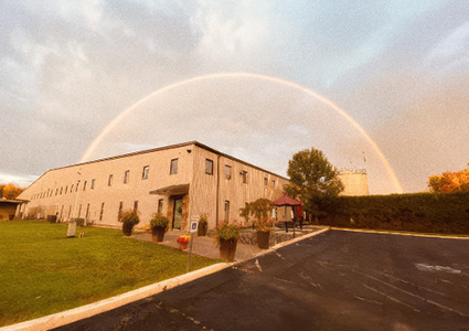 a scenic moment featuring a rainbow spanning over a building