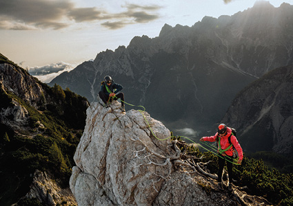 two alpinists climbing a rugged peak