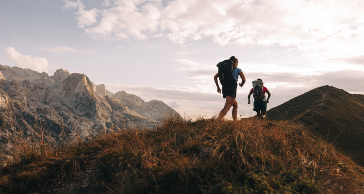 people hiking in a mountainous region,