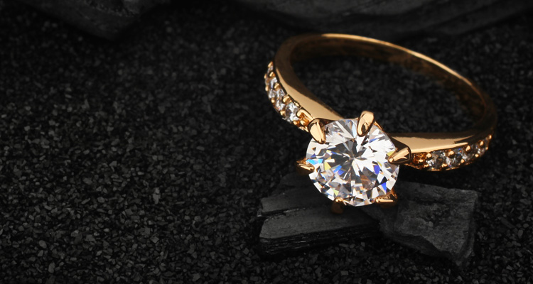 a gold diamond engagement ring featuring a prominent central stone and smaller accent diamonds on the band