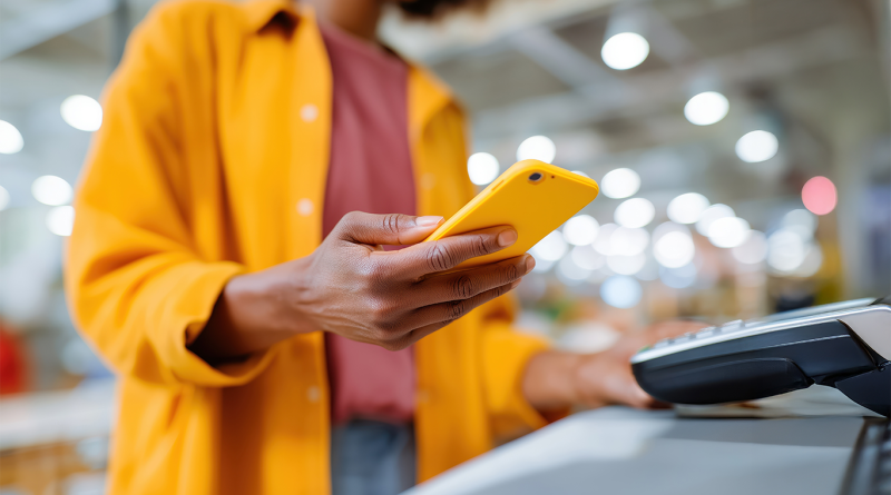Customer using a smartphone for contactless payment at a retail checkout in a modern US store environment