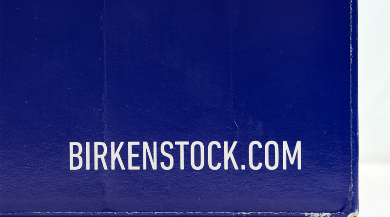 Close-up of a blue Birkenstock shoe box featuring the Birkenstock.com logo in white lettering.