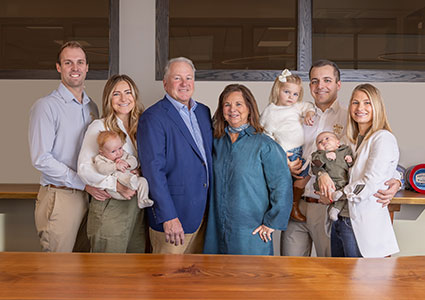 Scott Meister, a third-generation owner of Meister Cheese. He is pictured here posing alongside his family