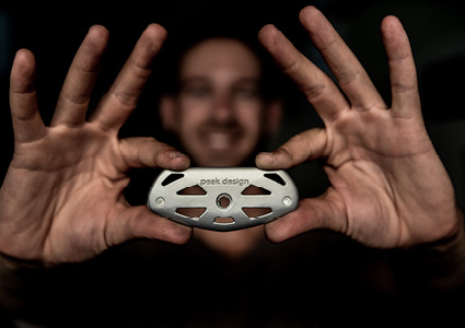 Peter Dering, the founder of Peak Design, holding an early CNC-machined metal prototype plate for the Peak Design Capture Camera Clip
